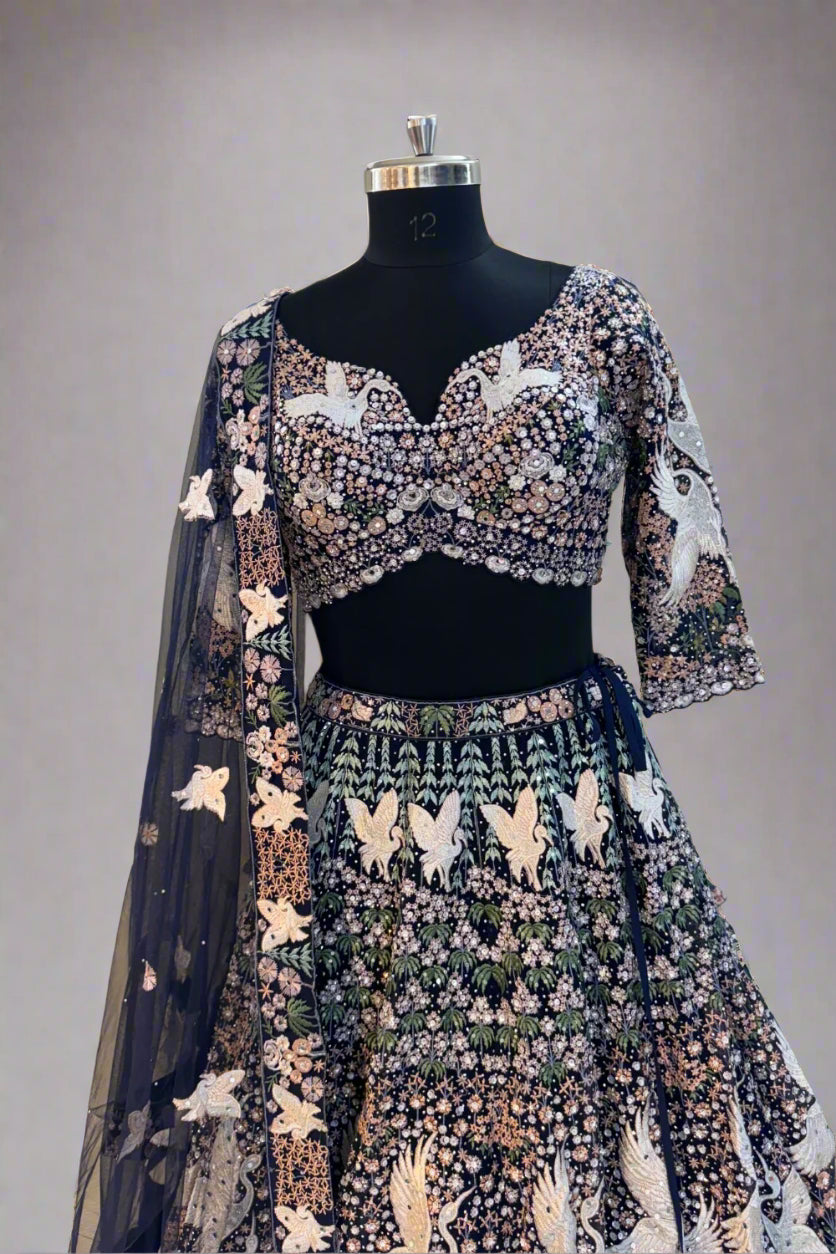 Elegant navy blue net lehenga set with intricate white swan embroidery and floral sequin detailing