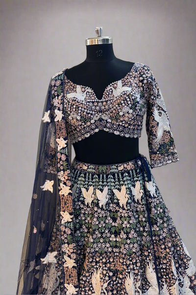 Elegant navy blue net lehenga set with intricate white swan embroidery and floral sequin detailing